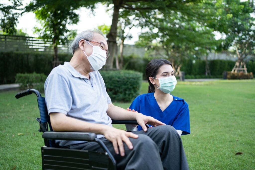 Support disabled senior elder man on wheelchair at green park